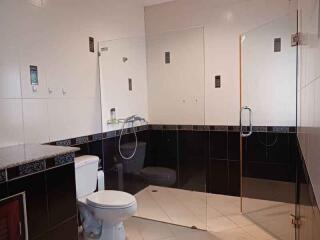 Modern bathroom with glass shower and white fixtures