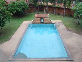 Outdoor swimming pool with water feature