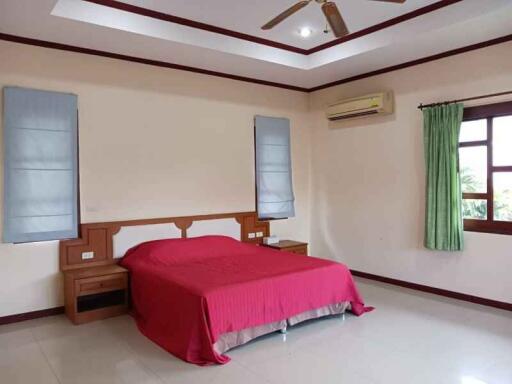 Bedroom with bed, air conditioning, and window