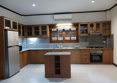 Modern kitchen with wooden cabinets and central island