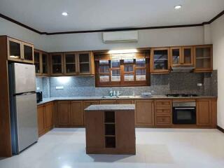 Modern kitchen with wooden cabinets and central island