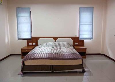 Spacious bedroom with double bed and two windows