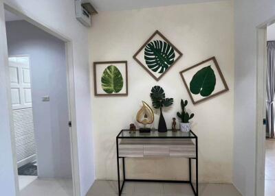 Nicely decorated hallway with modern art and plants