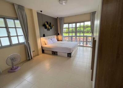 Spacious bedroom with double bed and large windows