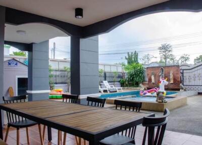 Outdoor area with pool and dining table