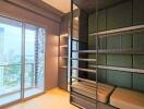 Bedroom with green bunk beds and a large window overlooking a cityscape