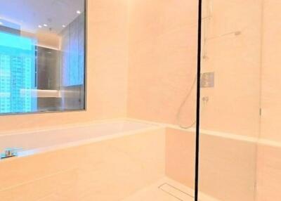 Modern bathroom with bathtub and glass shower enclosure