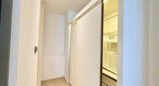 Well-lit organized closet with sliding doors