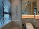 Modern bathroom with glass shower and large window