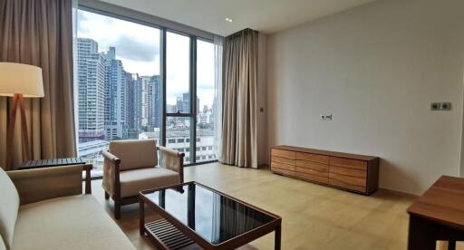 Spacious living room with large windows and city view