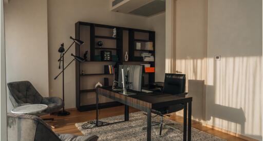 Modern home office with desk, chairs, and shelving