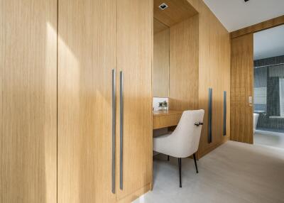 Spacious dressing room with built-in closets and seating area