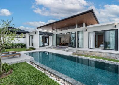 Modern house with pool and green yard