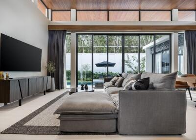 Modern living room with large windows and pool view