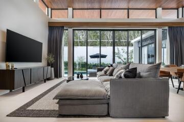 Modern living room with large windows and pool view