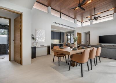 Modern open-concept living and dining area with wooden ceiling and contemporary furniture