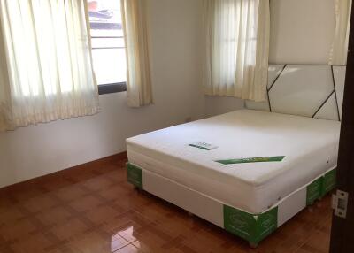 Bright bedroom with new mattress and tiled floor