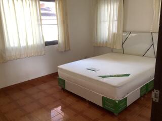 Bright bedroom with new mattress and tiled floor