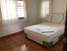 Bright bedroom with new mattress and tiled floor