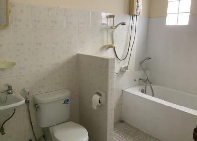 A bathroom with a toilet, bathtub, and shower
