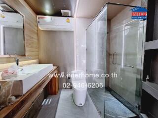 Modern bathroom with glass shower and wooden elements