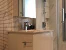 Modern bathroom with a sink, mirror, and frosted window