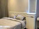 Bedroom with double bed, curtains, and illuminated mirror unit