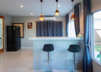 Modern kitchen with bar stools and pendant lighting