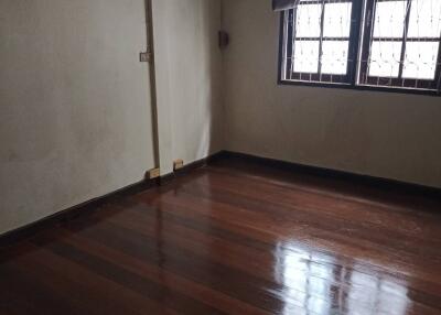 Empty bedroom with hardwood flooring