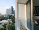 Balcony view with outdoor seating and cityscape in the background