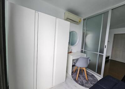 Modern bedroom with wardrobe, desk, and air conditioning