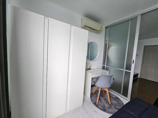 Modern bedroom with wardrobe, desk, and air conditioning