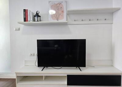 Living room with TV and shelving
