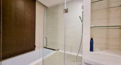 Modern bathroom with glass shower door and wooden blinds