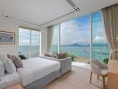 Modern bedroom with large windows and ocean view