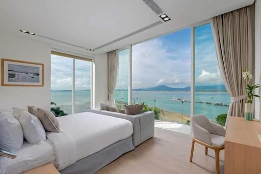 Modern bedroom with large windows and ocean view