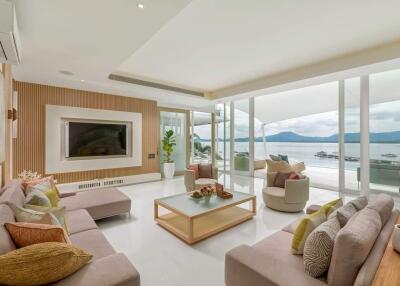 Modern living room with large windows and a waterfront view