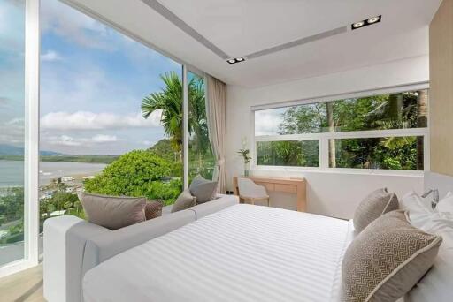 Modern bedroom with large windows and a scenic view