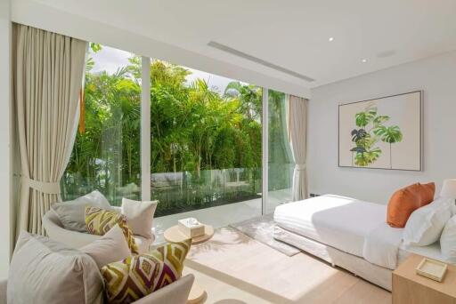 Spacious bedroom with large windows and garden view