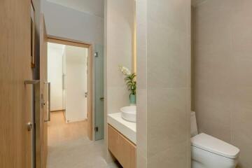 Modern bathroom with wooden accents and white fixtures