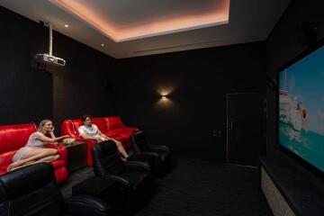 A modern home theater with comfortable seating and a projector screen