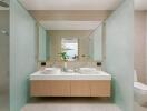 Modern bathroom with double sink and frosted glass partitions