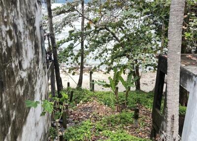 Outdoor area with a view of the beach and surrounding greenery