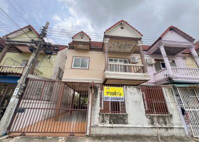 Front view of a residential building with a gated entrance