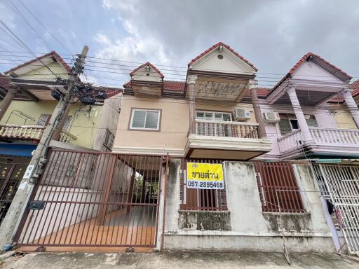 Front view of a residential building with a gated entrance