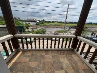 Balcony view with tiled flooring and surrounding neighborhood