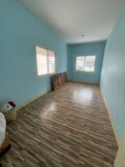 Spacious bedroom with large windows and tiled floor