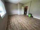 Empty bedroom with wooden floor