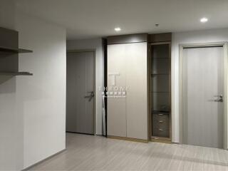 Modern apartment entrance with closed doors and built-in storage