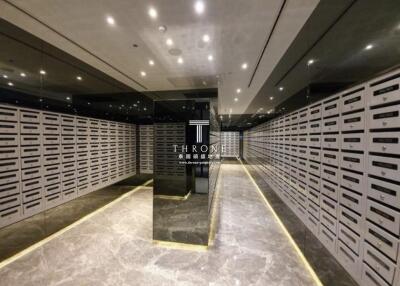 Mailroom with numerous mailboxes and modern lighting